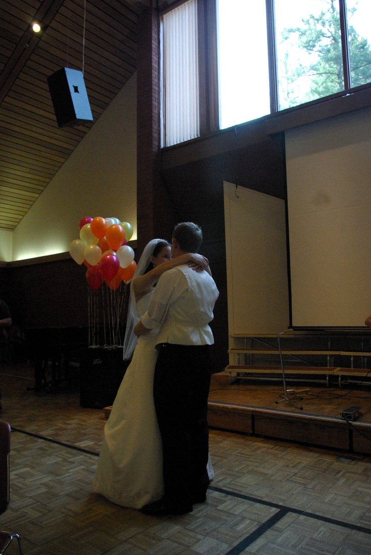 The couple dancing under the high timber ceiling of the fellowship hall
